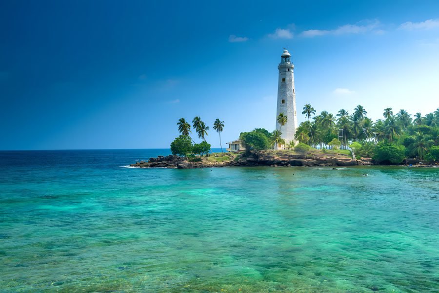 Lighthouse over turquoise water on the south coast