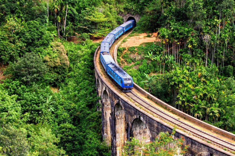 The blue train crossing the Nine Arch Bridge